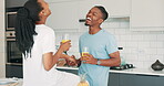 Couple, drinking juice and conversation for love, relaxing and fruit smoothie or nutrition at home. Black people, happy and communication in kitchen, wellness and security in marriage on morning