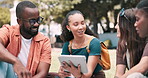Tablet, education and student group outdoor on college campus to study for exam or test together. Technology, learning or scholarship with group of young friends on field of grass at university