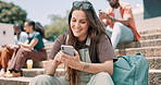 Happy woman, smartphone and student typing at university, social media and reading funny meme at steps. Phone, laughing or person in college for joke, scroll or mobile app outdoor with wind at campus