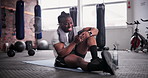 African man, phone and happy in gym with texting for notification, chat or web blog for training. Person, smartphone and smile for reading on app for exercise, workout or social media at fitness club