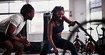 Woman, personal trainer and battle rope at gym for workout, exercise or muscle endurance in fitness motivation. Serious, active female person with coach in stamina, cardio or intense sweat training