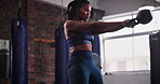 Black woman, kettlebell and weightlifting at gym for workout, strength or body exercise. Active African female person, athlete or bodybuilder in sports, muscle gain or training in health and wellness
