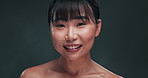 Face, skincare and Asian woman laugh in studio for cosmetic, wellness or treatment on black background. Beauty, portrait or happy Japanese  model smile for glowing skin, satisfaction or shine results