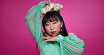 Face, natural beauty and Asian woman with flower crown in hair at studio isolated on a pink background. Portrait, wreath and floral cosmetics of Korean model in organic skin makeup, fashion or smile