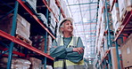 Senior woman, arms crossed and warehouse for logistics, shipping business and boss with pride and smile. Supply chain, distribution industry and management at storage facility for package inspection