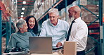 Warehouse, business people and group with a laptop, conversation and brainstorming with planning. Teamwork, manufacturing and company with executives and ideas with online reading and research