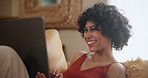 Relax, laptop and woman laughing on a sofa for movie day, film or streaming comic entertainment in her home. Pc, search and female person in a living room with online comedy, subscription or show