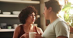 Couple, lgbtq and drinking coffee on morning, communication and bonding or security in relationship. Lesbians, people and talking on weekend in kitchen, tea and care in partnership and hot beverage