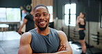Black man, fitness and professional personal trainer in confidence for workout, exercise or training at gym. Portrait of African male person or bodybuilder with smile and arms crossed at health club