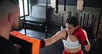 Sports, exercise or boxing with woman and coach at gym for training, practice or spar in preparation for fight. Fitness, health or workout with boxer and personal trainer together for self defense