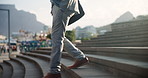 Businessman, legs and walking down stairs in city for travel, opportunity or commute to work. Closeup of male person or employee in business fashion or immigration with feet or shoes on outdoor steps