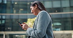 Business woman, phone and social media in city for communication or outdoor networking. Happy, female person or employee walking with mobile smartphone for online chatting or texting in an urban town