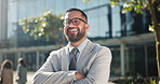 Smile, arms crossed and business man in city for corporate career, opportunity or inspiration. Portrait, happy and confident young corporate employee in suit for professional work at urban town