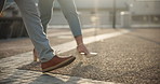 Legs two businesspeople , walking in road and sunny morning closeup. Unrecognisable office colleagues feet , stepping street pavement to work. High heels businesswoman strolling with stylish man