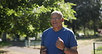 Mature, man and running in park for exercise, outdoor and healthy cardio workout in nature with trees of forest. Fitness, person and runner on path with benefits of wellness in retirement or summer 