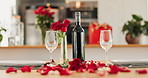 Wine, flowers and romance on valentines day for celebration of love, anniversary or honeymoon in still life. Glass, dinner and elegant date in dining room of home for event, milestone or occasion