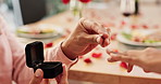 Couple, hands and proposal with ring for love, marriage and celebration on valentines day or anniversary dinner. Closeup of people with jewelry for engagement with finger for romance and commitment