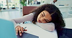 Laptop, bored and tired with business woman lying on desk in office with fatigue or exhaustion from work. Computer, burnout or depression and frustrated, unhappy or moody young employee in workplace