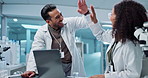 Scientist, teamwork and high five with laptop in laboratory for test breakthrough, pharmaceutical review or success. Science, collaboration or technology for research, discussion and digital analysis