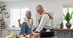 Cooking, kitchen and mature couple with apron for meal prep, nutrition and happy marriage support together at lunch. Diet, man and woman with healthy food recipe, help and salad for dinner in home.