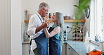 Couple, kitchen and dance with commitment, trust and support for communication, celebration and retirement. Senior people, smile and cooking for conversation, hug and love with holiday or vacation