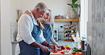 Old couple, cooking and vegetables in kitchen or together for healthy eating or dinner, bonding or nutrition. Man, woman and raw ingredients on board with conversation for wellness, meal prep or diet