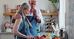 Woman, man and knife with vegetables in kitchen cooking for healthy nutrition for dinner, diet or conversation. Happy couple, meal prep and chat at counter for marriage bonding, fibre or ingredients