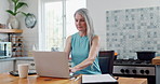 Laptop, coffee and mature woman in kitchen for research online with freelance creative project. Technology, cappuccino and senior female freelancer designer typing email on computer at apartment.