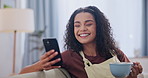 Smile, phone and coffee with woman on sofa in living room of home for communication or networking. Mobile, app and social media with happy young person drinking warm beverage in apartment to relax