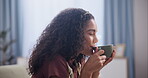 Female person, drink and coffee at home, sofa and relax after productive day at work with curly hair and profile. Woman, tea and enjoy from cup, couch and leisure time in house in lounge after campus