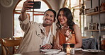 Selfie, dating and couple talking in restaurant together for love, romance or anniversary celebration. Photograph, smile or conversation with man and woman at romantic dinner for valentines day date