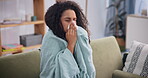 Woman, sick and sneeze at home, sofa and blanket to relax, recover and keep warm from winter season. Female person, flu and tissue with throw, couch and pillow at the house to isolate and cough