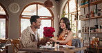 Surprise, roses and couple on date in restaurant for valentines day, anniversary or romance celebration. Happy, love and young man and woman with bouquet of flowers at dinner, supper or lunch at cafe