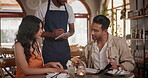 Waiter, restaurant and order with food, man and woman at table on date Italian cuisine with wine. Closeup, lasagne and date at bistro with spaghetti, pasta and table for dinner or lunch service