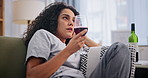 Sad, wine and drunk with bored woman on sofa in living room of home to relax or drink. Depression, frustrated or unhappy and young alcoholic person drinking in apartment with mental health problems