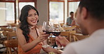 Love, toast and couple dating in restaurant together for romance, anniversary or celebration. Smile, red wine or fine dining with man and woman at romantic dinner to toast on valentines day date