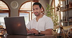 Typing, research and man with laptop in coffee shop with remote work for creative project. Smile, technology and young male freelance designer reading email on internet with computer in cafe.