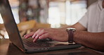 Typing, laptop and hands of man in coffee shop for remote work, freelance career and working online. Restaurant, cafeteria and closeup of business person on computer for website, internet or proposal