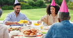 Family, men and women at birthday party in garden with hat, happy and giving food at brunch in summer. People, relax and holiday with celebration, event and together for eating corn in home backyard