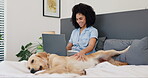 Woman, dog and happy in bedroom with laptop for email, morning routine and social media search in home. Person, animal and pet on bed with playing, distracted and smile for remote work and freelancer