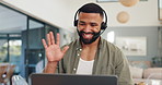 Man, headset and video call with wave or home as freelancer for online meeting, telemarketing or consulting. Male person, laptop and virtual conversation in apartment for mic, advisor or tech support