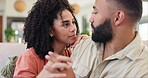 Couple, talking on couch and holding hands for love and bonding at home, conversation and happiness with support. Commitment, trust and connection, people in relationship with story and time together