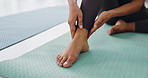 Pain, yoga mat and woman with ankle injury for fitness pilates exercise or workout in gym. Accident, hurt and closeup of female person massaging foot muscle sprain or bruise with medical emergency.