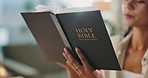 Hands, reading and woman with bible at apartment for worship, religion or spiritual wellness. Praise, healing and closeup of female person studying holy book for christian faith and peace at home.