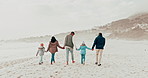 Family, holding hands and parents with children on beach for holiday, vacation and adventure in winter. Grandparents, travel and mother, father and kids for bonding, relationship and relax by sea