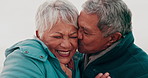 Senior couple, kiss and cheek on vacation for love, connection and silly laugh for relationship. Elderly man, old woman and happy by ocean for holiday with hug, outdoor and nature with comic memory