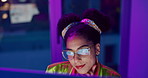 Computer, face and neon with programmer woman in office at night for coding or developing. Smile, typing and glasses with happy young game developer in workplace for system or interface upgrade