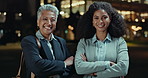 Business woman, night and city with professional for career opportunity, ambition or confidence. Portrait of employees or coworkers with smile and arms crossed for late evening in an urban town