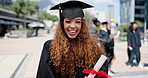 Face, education and graduation with black woman outdoor on campus of college of university. Portrait, certificate and success with happy young student laughing in celebration at school ceremony