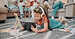 Girl, tablet and headphones in living room for education, video and online entertainment on carpet. Kid, technology and relax on floor with audio support for development, knowledge and elearning